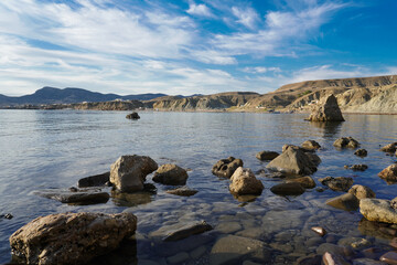 Mountain sea bay panorama. Beautiful Crimean nature landscape. Beautiful seashore with different stones.