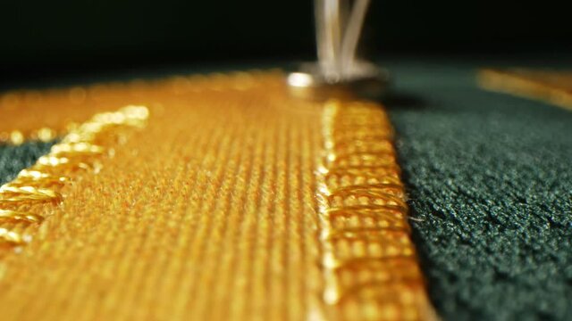 Embroidery machine makes detail of hockey logo on uniform