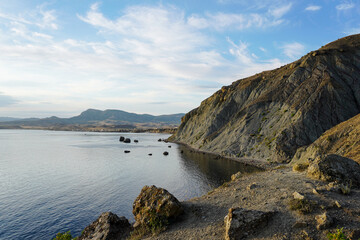 Fototapeta premium Mountain sea bay panorama. Beautiful Crimean nature landscape. Beautiful seashore with different stones.