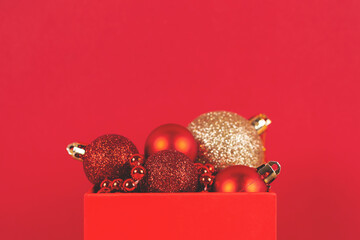 Red Christmas background with holiday decorations. Copy space. Soft selective focus.