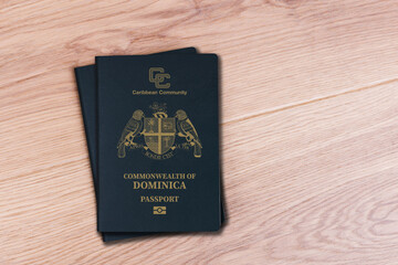 two dominica passports on white wood background, space for texts