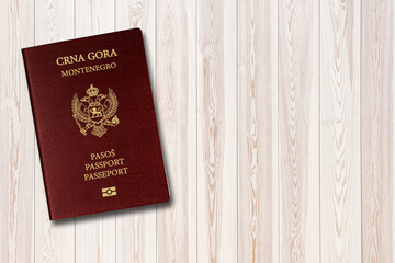 Montenegro passport on white wood background, space for texts