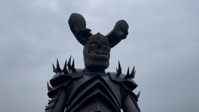 Mutant warrior stands and holds mace in his hands.