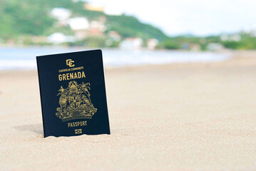 Grenada passport on the beach sand ,Space for writing
