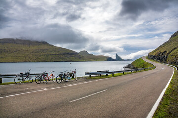 Bicycles parked near high slope iconic road in Faroe Islands