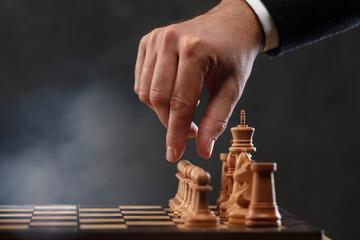 The chess player is about to move the white pawn forward.