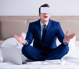Businessman wearing a virtual reality headset in the bedroom