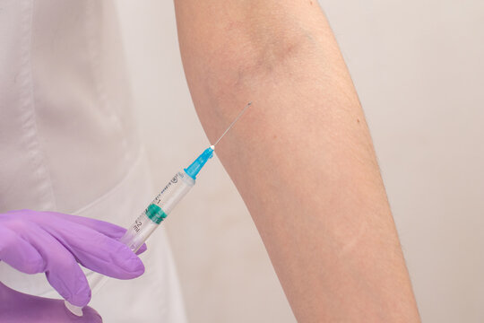 Close Up Nurse Hands On Gloves Makes An Injection To Hand Patient