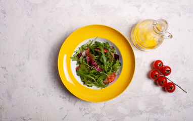 Arugula salad, red cabbage, tomatoes, olive oil.
