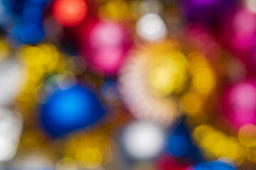 Defocused Xmas festive decorations, abstract blurry bokeh background effect. Out of focus glowing lights celebration texture for use at graphic design. Christmas composition for Happy New Year.