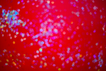 silver sparkles on a bright red background. selective focus, blur