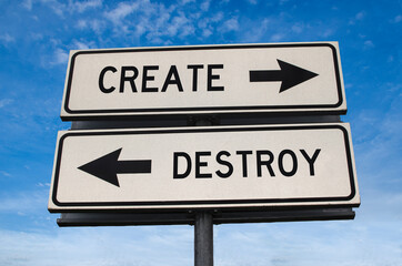 Create versus destroy. White two street signs with arrow on metal pole with words. Directional...