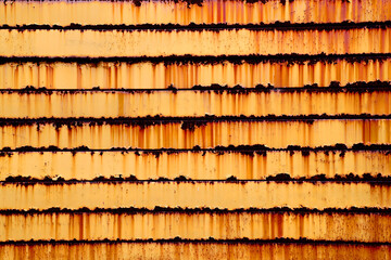 Heavy rusted orange iron wall