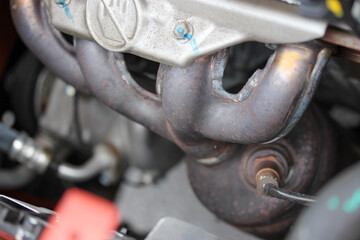 Fototapeta na wymiar Compact car engine exhaust manifold
