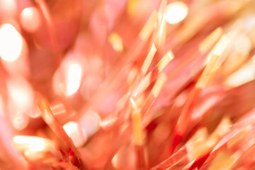 blurred bokeh close up of christmas tinsel decoration festive backdrop