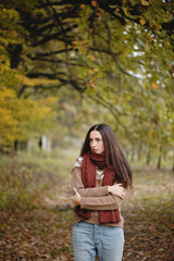Beautiful long haired woman in autumn park.