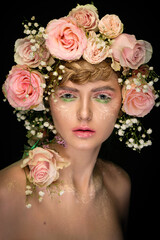 Obraz premium portrait of a beautiful girl with skillful makeup and hair decorated with live roses