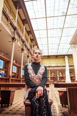 young pretty blond girl posing in fashion style at vintage europe hall interior, lifestyle rich people concept