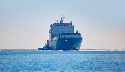 Tugboat assisting cargo ship at Mersin port - Mersin, Turkey 