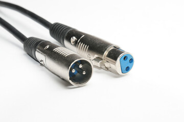 Audio cable with XLR connectors for microphones and professional audio equipment on a white...