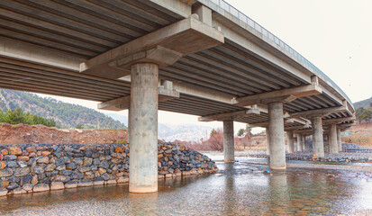 Highway overpass viaduct from below - Empty road surface floor with city overpass viaduct bridge