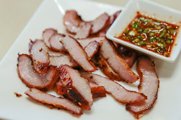 Thai Grilled Pork Neck with Spicy Dipping Sauce on white isolated.