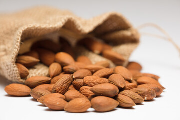 almonds with raffia sack, white background
