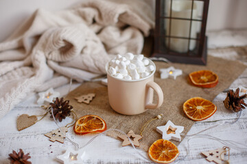 Christmas composition, mug with cocoa and marmalade on a wooden background