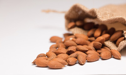 almonds with raffia sack, white background

