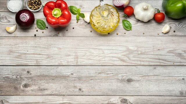 Variety of vegetables on the top border of gray wooden background