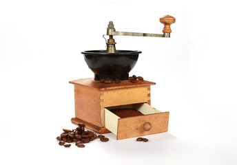 Old coffee grinder with coffee beans isolated on a white background
