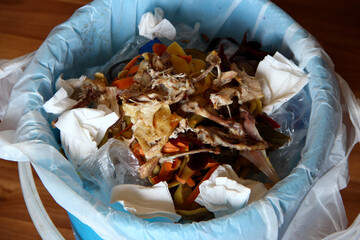 Trash can in the kitchen with leftover food