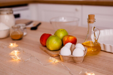 Ingredients for traditional apple pie: apples, eggs, butter, sugar, cinnamon and flour. New Year's Eve concept