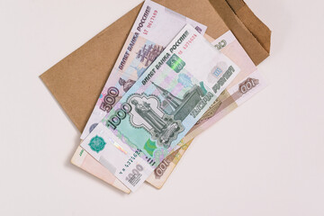 Russian money is on the envelope. Paper bills of five hundred and one thousand rubles. A stack of banknotes for payments of pensions, wages, benefits and other social benefits