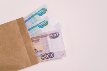 Stack of cash Russian money and an envelope on a white background. Avoiding company taxes.