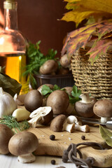 Mushrooms, spices and greens on a wooden board.