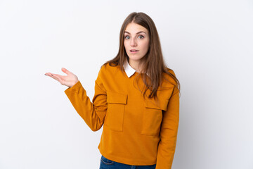 Young woman over isolated white background making doubts gesture