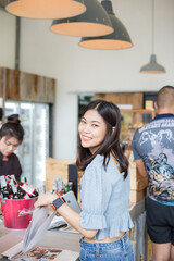 Beautiful women order coffee drink stand on counter in cafe