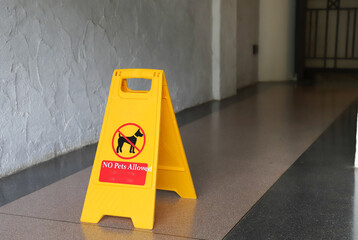 Closeup of no pet allowed sign on the floor.