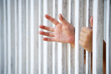 Obraz premium close up of prisoner hand in jail
