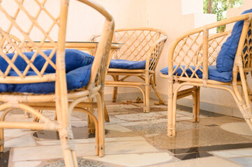 wicker wooden chairs and coffee table for relaxing and socializing with family or friends on the...