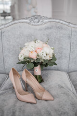 beige bridal wedding shoes and bridal bouquet with roses