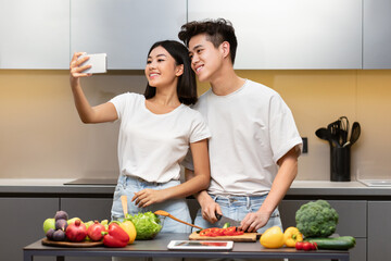 Happy Asian Couple Making Selfie Cooking In Kitchen At Home