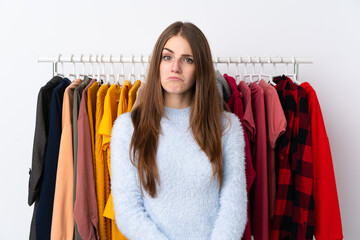 Young woman in a clothing store sad