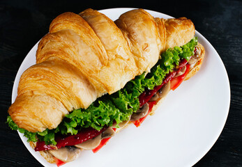 Photo of fresh tasty croissant on white plate