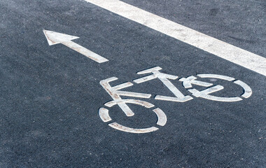 Fototapeta premium Bicycle symbol on a bike lane with directional arrow