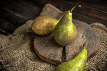 Green pears, fresh fruits on wooden background