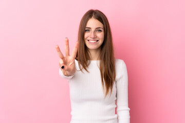 Young woman over isolated pink background happy and counting three with fingers