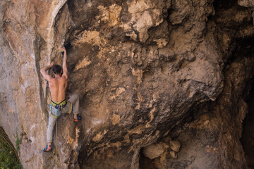A man trains strength and endurance, rock climbing in Turkey