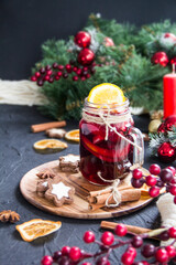 Christmas hot mulled wine with cinnamon cardamom and anise. Dark vintage dirty background. Creative atmospheric decoration